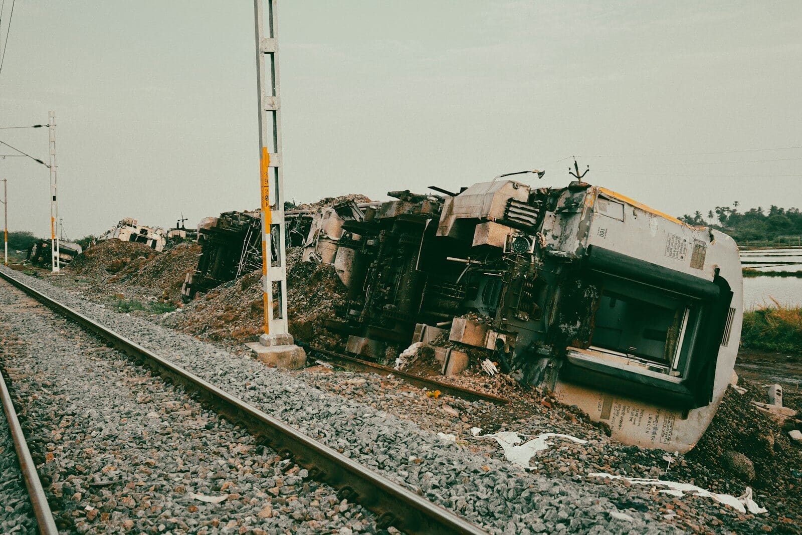 A train appears derailled and severely damaged