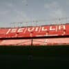 A large stadium with red seats and